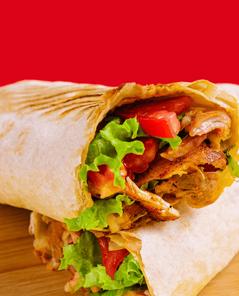 shawarma-with-chicken-tomatoes-and-lettuce-on-a-wo-TBUSS9C.png